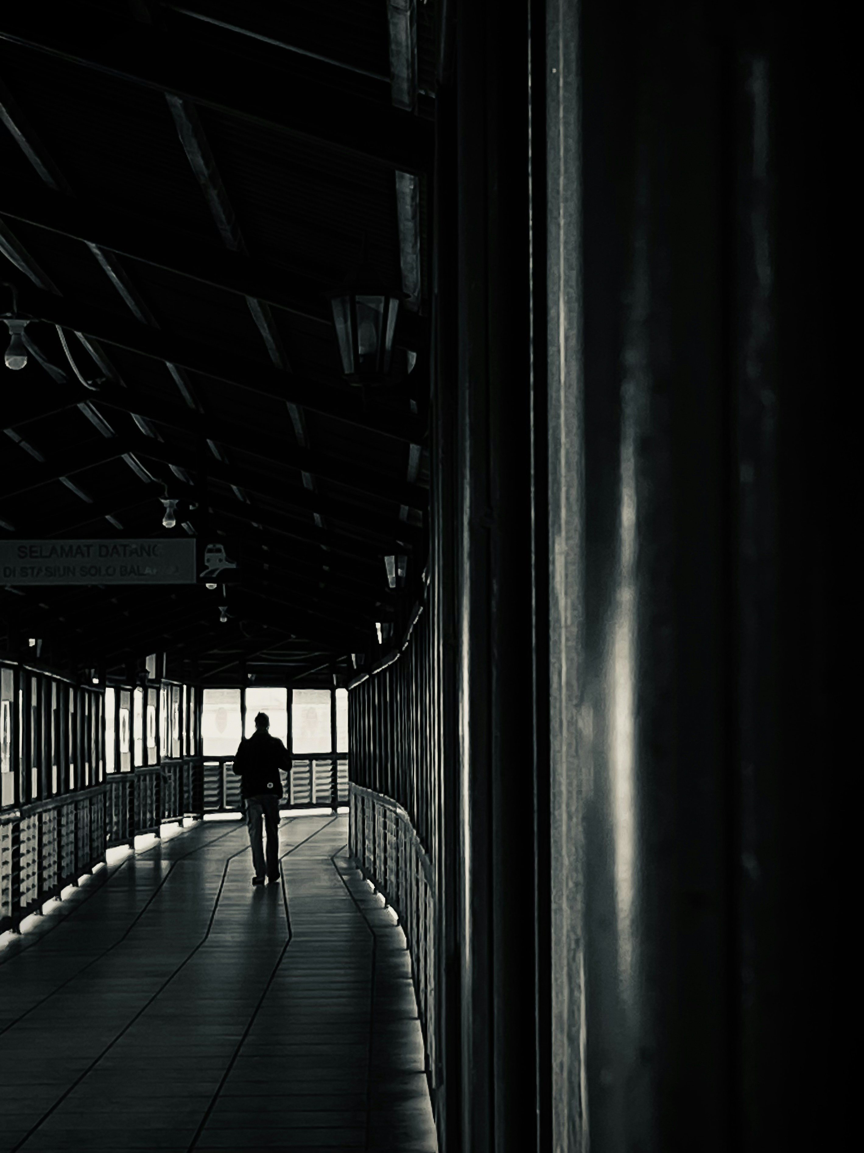 A shadow of a figure cast against a wall in a hallway